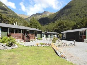 a group of buildings with mountains in the background at Arthur's Pass Alpine Motel in Arthur's Pass +34 photos