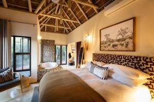 a bedroom with a large bed in a room at Villa Blaaskans in Hoedspruit +61 photos