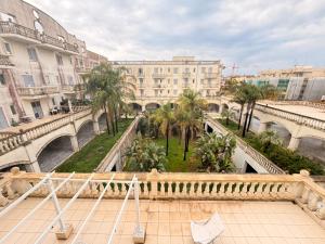 a view of a building with palm trees and a bridge at Luxury House Gallipoli in Gallipoli