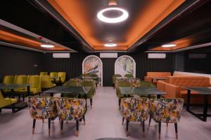 a restaurant with tables and chairs in a room at Sylhet Regency Ltd in Sylhet