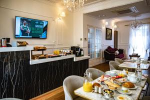 a dining room with a table with food on it at La Maison Gobert Paris Hotel Particulier in Paris