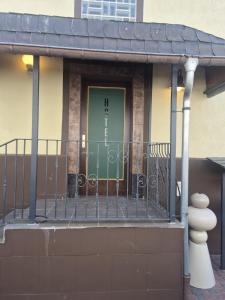 a front door of a house with a gate at Waterloo Sunset Hotel in Erzhausen
