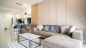 a living room with a couch and a table at Continew Residence Cozy Suite by GUESTONIC in Kuala Lumpur