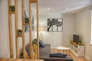 a living room with a staircase in a house at Fleur des Vents in Saint-Flour