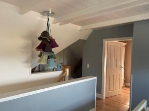a room with a staircase with a mirror and a chandelier at Cora in Pruchten