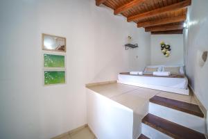 a white room with a bed and some stairs at Villa Koomas-Mountain View - kakodiki Paleochora in Avdhoulianá +37 photos
