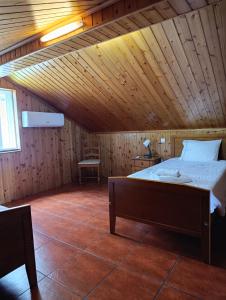 a bedroom with a bed in a wooden ceiling at Casa Azul (Blue House) in Urzelina