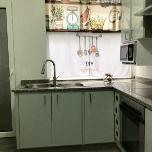 a kitchen with a sink and a counter at Piso en el centro de Viveiro in Viveiro +18 photos