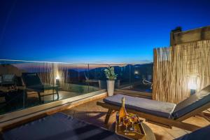 a balcony with a view of the mountains at night at Villa Koomas-Mountain View - kakodiki Paleochora in Avdhoulianá