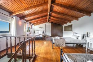a living room with two beds and a balcony at Villa Koomas-Mountain View - kakodiki Paleochora in Avdhoulianá
