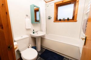 a bathroom with a toilet and a sink and a bath tub at Sound House, Shetland Islands in Lerwick