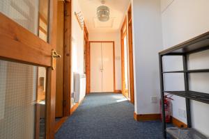 an empty hallway with a door and a room at Sound House, Shetland Islands in Lerwick