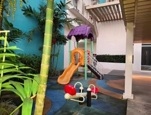 a playground in a house with a slide at Jade's Place Condo in Bacolod