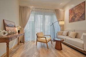 a living room with a couch and a table at Home en Lagom in Hanoi