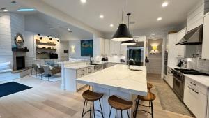 a large kitchen with a large island with bar stools at Ruffino Retreat in Union Pier