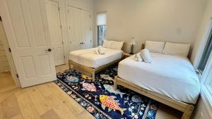 a bedroom with two beds and a rug at Ruffino Retreat in Union Pier +41 photos