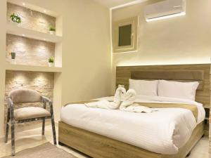 a bedroom with a bed with towels on it at Seven Pyramids View Inn - Rooftop Breakfast in Cairo