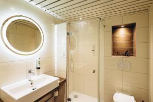 a bathroom with a sink and a shower at Hotel Scholz in Aalen +38 photos