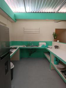a bathroom with green and white counters and a sink at Turquesa Bacalar Centro in Bacalar +22 photos