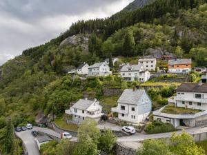 a village on a hill with houses and cars at Trolltunga Fjords in Tokheim