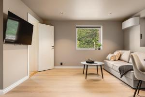 a living room with a couch and a table at Trolltunga Fjords in Tokheim