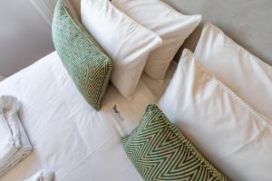 a group of pillows sitting on top of a bed at Douro View Charming Apartment Duplex in Valbom