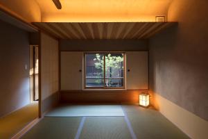 an empty room with a window and a light at Masarigusa Machiya House in Kyoto
