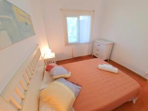 a small bedroom with a bed and a window at APARTAMENTO PALS BEACH-3 in Pals +16 photos