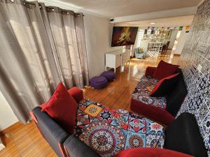 a living room with a couch and red pillows at Shalom_MatSofy in Santiago