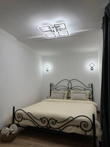 a bedroom with a bed in a white room at Comfort Forum House in Lviv +5 photos