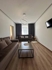 a living room with a couch and a table at Comfort Forum House in Lviv