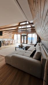 a living room with a large couch and a table at Black Roof in Arada