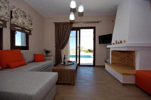 a living room with a couch and a fireplace at Villa Selene in Alonnisos
