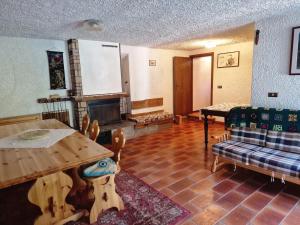 a living room with a table and a fireplace at maso denis in Canale San Bovo