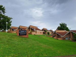 a sign in front of a row of houses at The Loft Getaway in Clarens