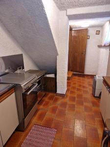 a kitchen with a sink and a stove in it at maso denis in Canale San Bovo
