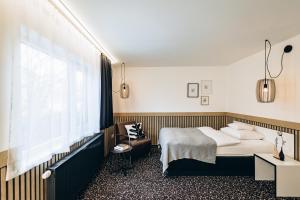 a hotel room with a bed and a window at Hotel Scholz in Aalen