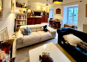 a living room with a couch and a table at Charming house in an old rectory PMR in Tréguier