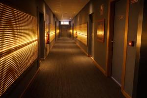 a long hallway with lights on the walls at Aparthotel Montcada in Montcada i Reixac +1 photo