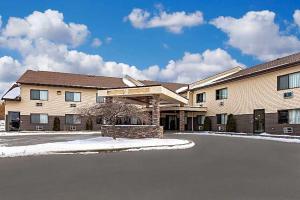 a large building with snow on the ground at Budget Inn in Ithaca
