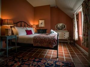 a bedroom with a bed and a table with a lamp at Killee Cottage in Mitchelstown
