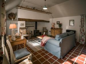 a living room with a couch and a fireplace at Killee Cottage in Mitchelstown