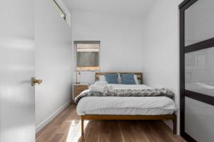 a bedroom with a bed in a white room at Spacious w/ 2BR 2Bath - Big Bear in Big Bear City