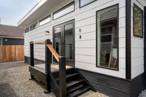 a black and white tiny house with a staircase at Spacious w/ 2BR 2Bath - Big Bear in Big Bear City