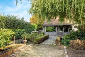 a house with a garden in front of it at Casiola - Authentic vacation home 'De Blauwe Kroon' in Oostkamp