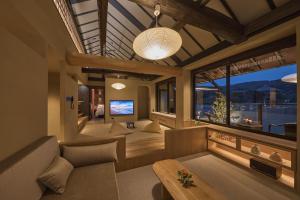 a living room with a couch and a large window at Hotel New Wakasa in Nara