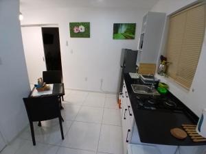a kitchen with a table and a stove top oven at Cayenas Apartament in Willemstad +3 photos
