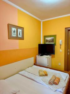 a bedroom with a bed with two towels on it at ApartMonte in Budva