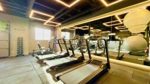 a row of treadmills in a gym at Studio Desing 3 - Lions Maceió in Maceió