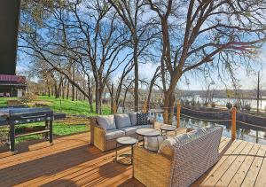 a wooden deck with two couches and a table at Lake Granbury House, Sleeps 11 with Lake Access! in Granbury